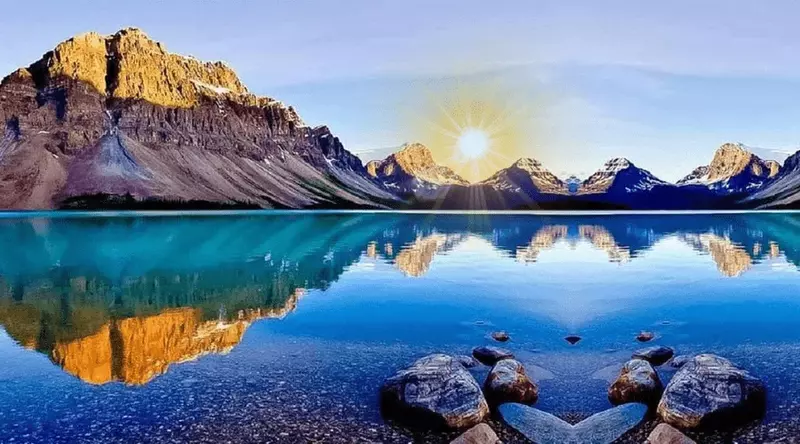 Reflections of Mountains in a Calm River